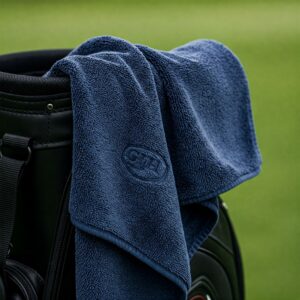 blue branded golf towel on black golf bag